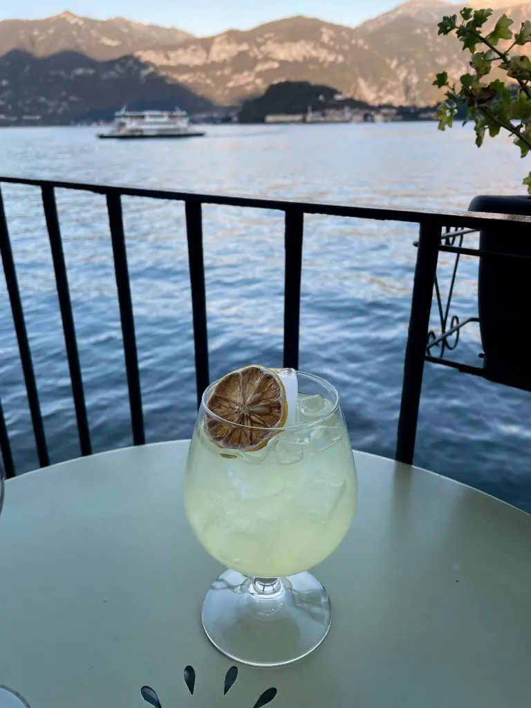 lake como aperitivo limoncello drink with lake view